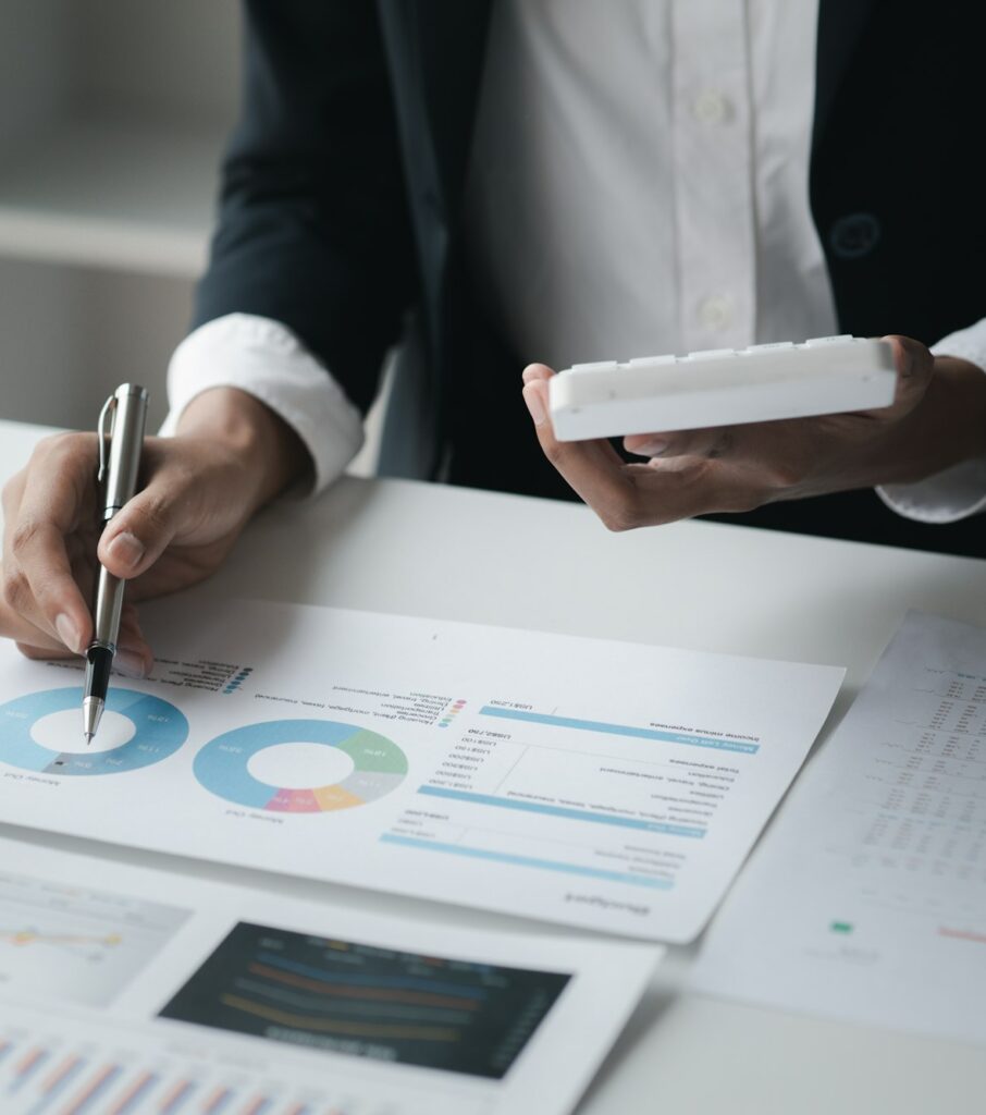 A female financier is reviewing company financial documents.